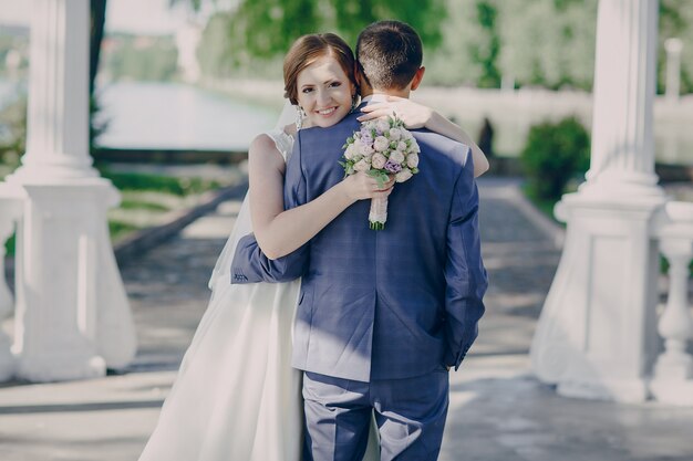 Happy bride hugging her groom