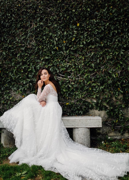 Happy bride woman in a wedding dress posing