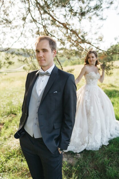 Happy brides are photographed in the woods in the summer