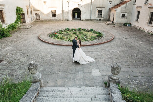 Happy brides dance near the castle