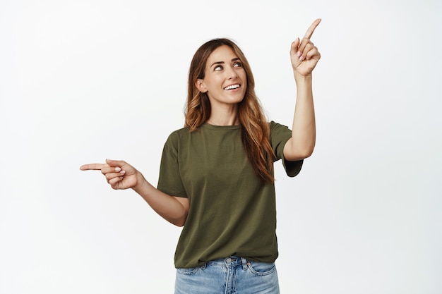 Happy brunette woman thinking making choice, looking at upper right corner and smiling thoughtful