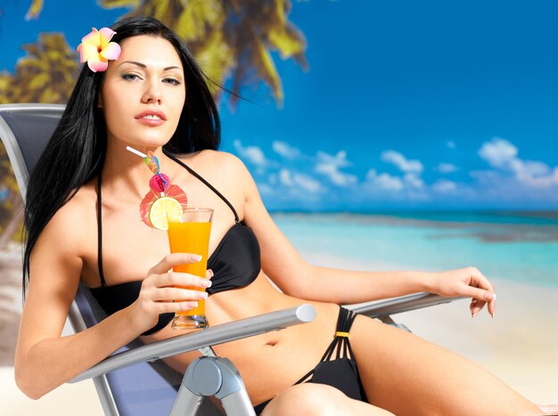 Happy brunette woman on vacation enjoying at beach