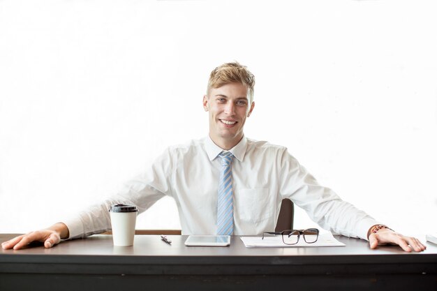 Happy Business Leader Sitting at Office Desk