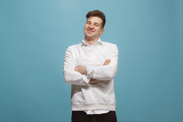 happy business man standing and smiling against studio