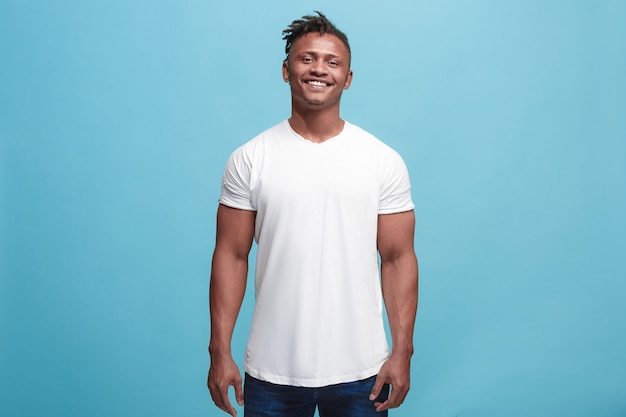 Happy business man standing and smiling isolated on blue studio.