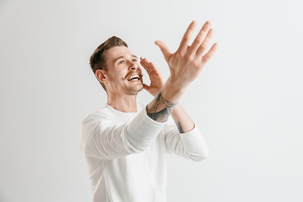 Happy business man standing, smiling isolated on gray studio wall