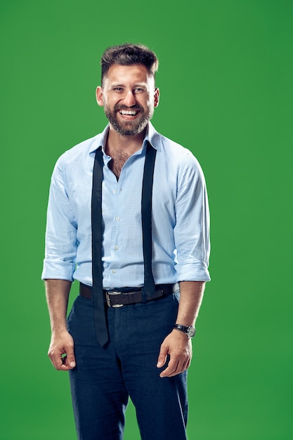 Happy business man standing and smiling isolated on green studio.