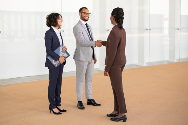 Happy business partners greeting each other