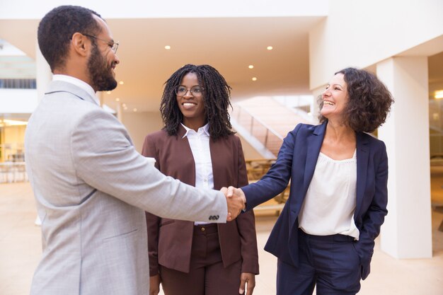 Happy business partners greeting each other