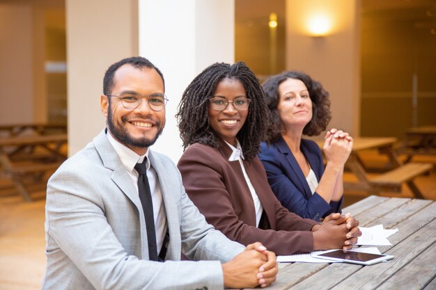 happy business people posing in outdoor cafe