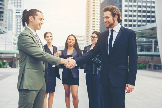 Happy business people shaking hands. Business success.