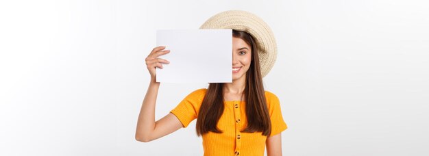 Happy business woman holding big white sign board gray wall back