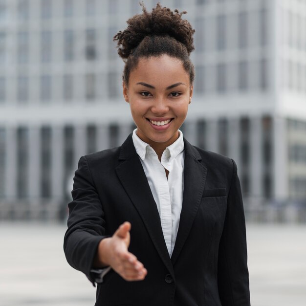 Happy business woman showing hand