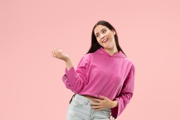 Happy business woman standing and smiling isolated on pink studio background.