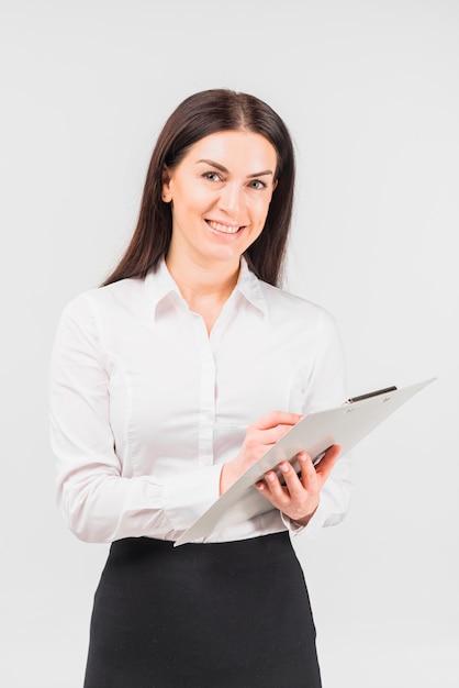 Happy business woman standing with clipboard
