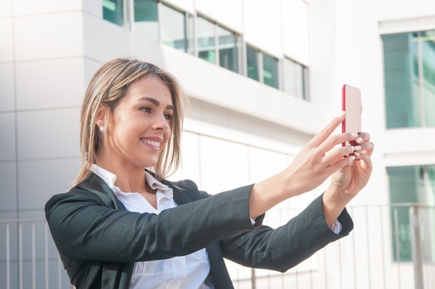 Happy business woman talking selfie photo outdoors