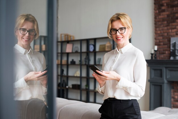 Happy business woman using smartphone 