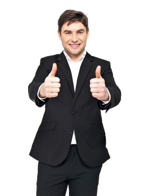 Happy businessman in black suit shows thumbs up sign isolated on white.