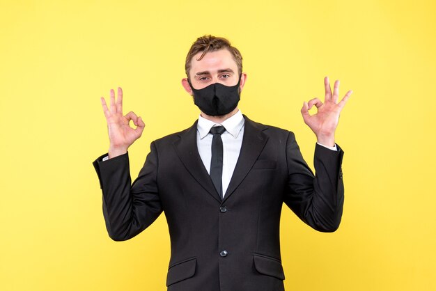 Happy businessman make double ok hand sign on yelow