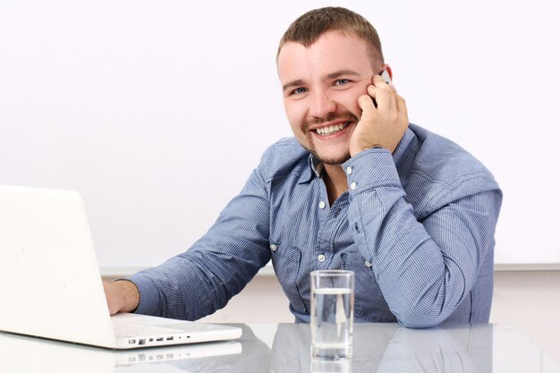 Free photo happy businessman talking by cellphone