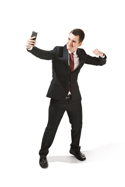 Happy businessman talking on phone over white in studio shooting.