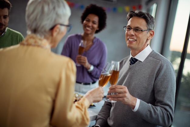 Happy businessman toasting with colleague on office party