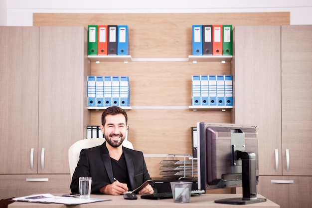 Happy Businessman working in his office. Businessperson in professional environment