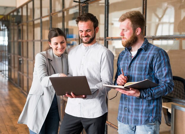 Happy businesspeople working together on project in office