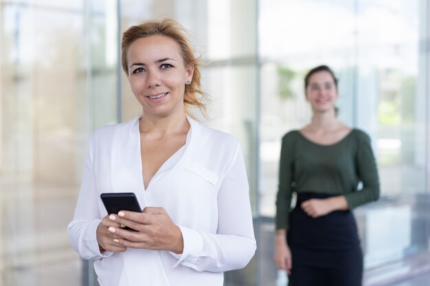 Happy businesswoman checking out chat