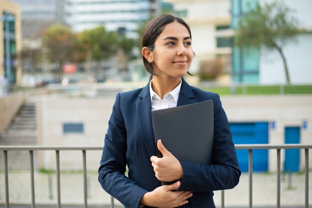 Happy businesswoman holding folder