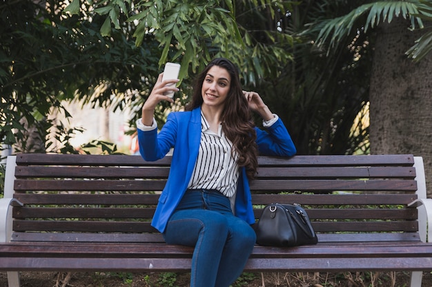 Free photo happy businesswoman taking a selfie