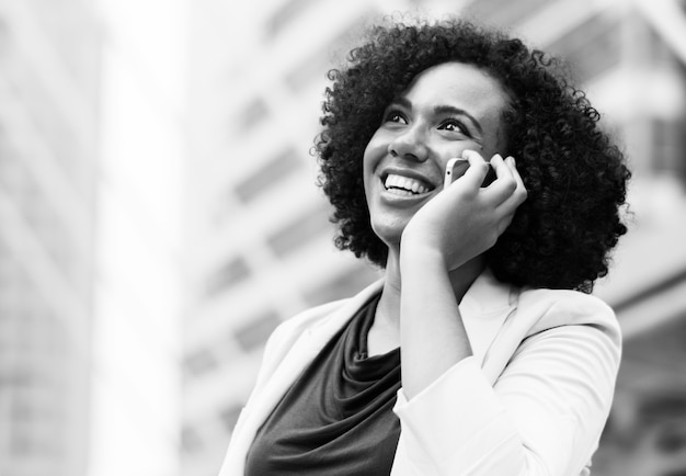 Free photo happy businesswoman talking on the phone