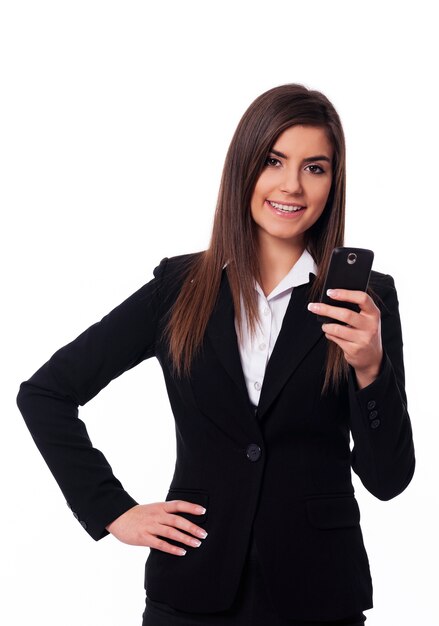 Happy businesswoman using smart phone