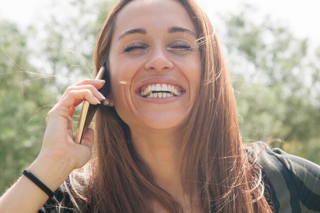 Happy carefree customer talking on phone