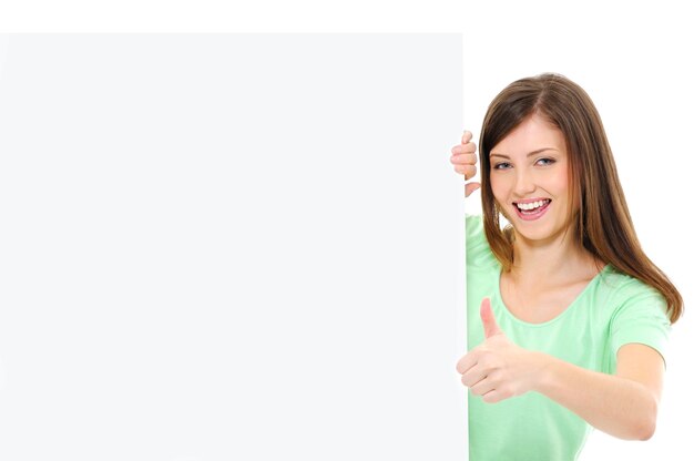 Happy casual female  with a blank banner showing thumbs-up