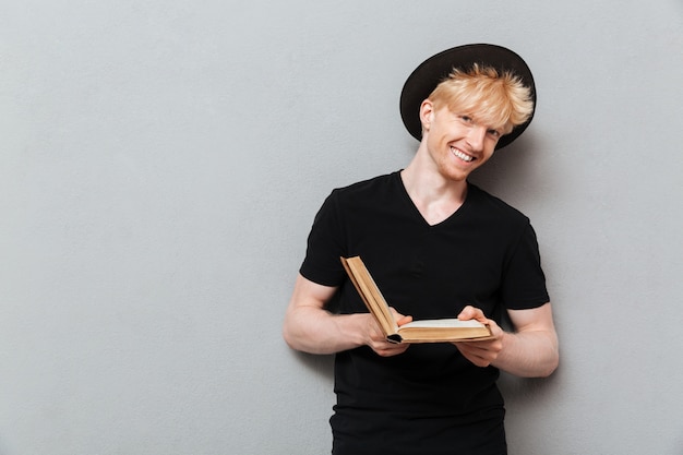 Free photo happy caucasian man reading book.