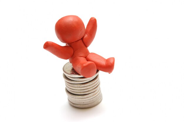 Happy character sitting on a mountain of coins