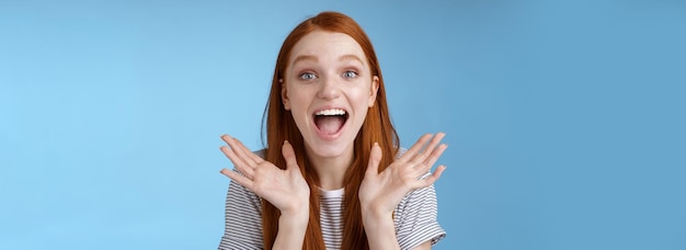 Free photo happy cheerful rejoicing young pretty redhead supportive girlfriend clasp hands joyfully yelling