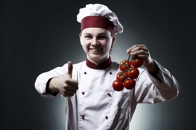 Happy chef with tomatoes