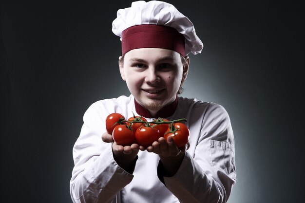 Happy chef with tomatoes