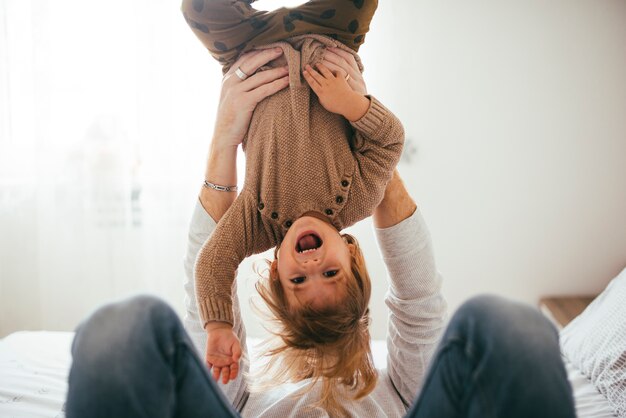 Happy child in arms upside down