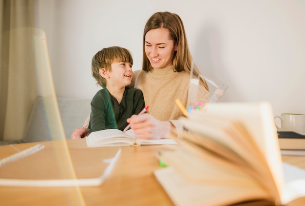 Free photo happy child being taught by teacher at home