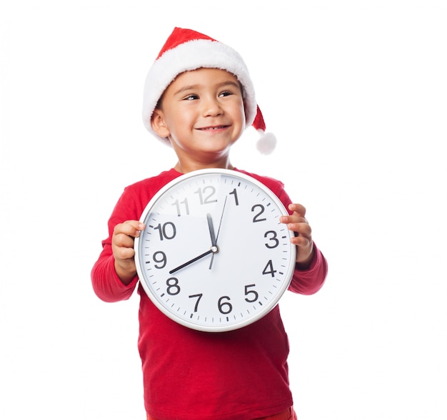 Happy child holding a big clock