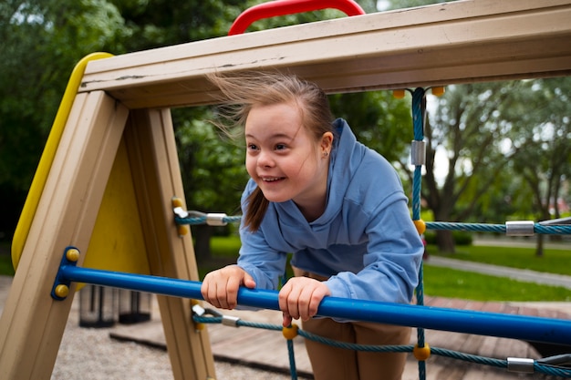 Happy child with down syndrome playing outside