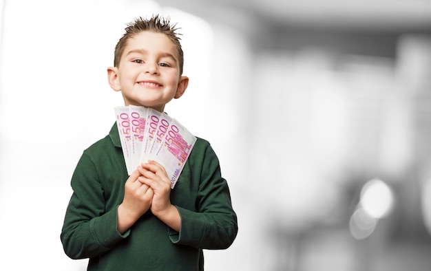 Happy child with many bills in hand