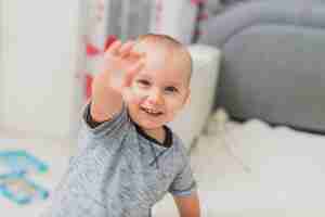 Free photo happy child with raised hand