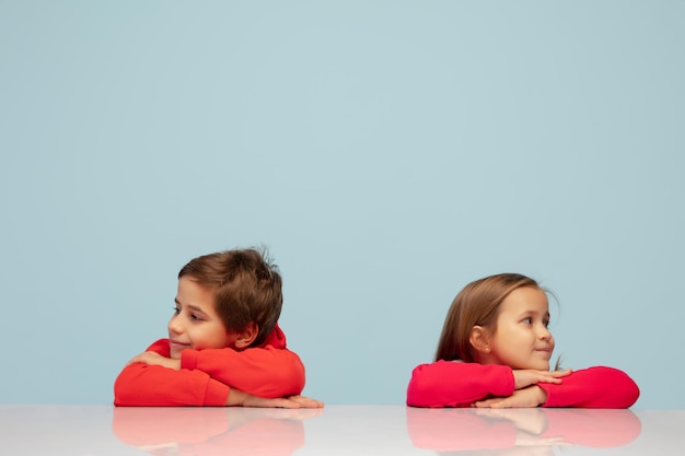 Happy children isolated on blue studio background Look happy cheerful sincere Copyspace Childhood education emotions concept