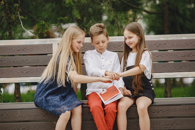 Happy children sitting together close and smile