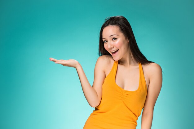 The happy Chinese girl on yellow background