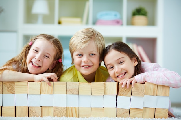 Foto gratuita compagni di classe felice dietro l'edificio in legno